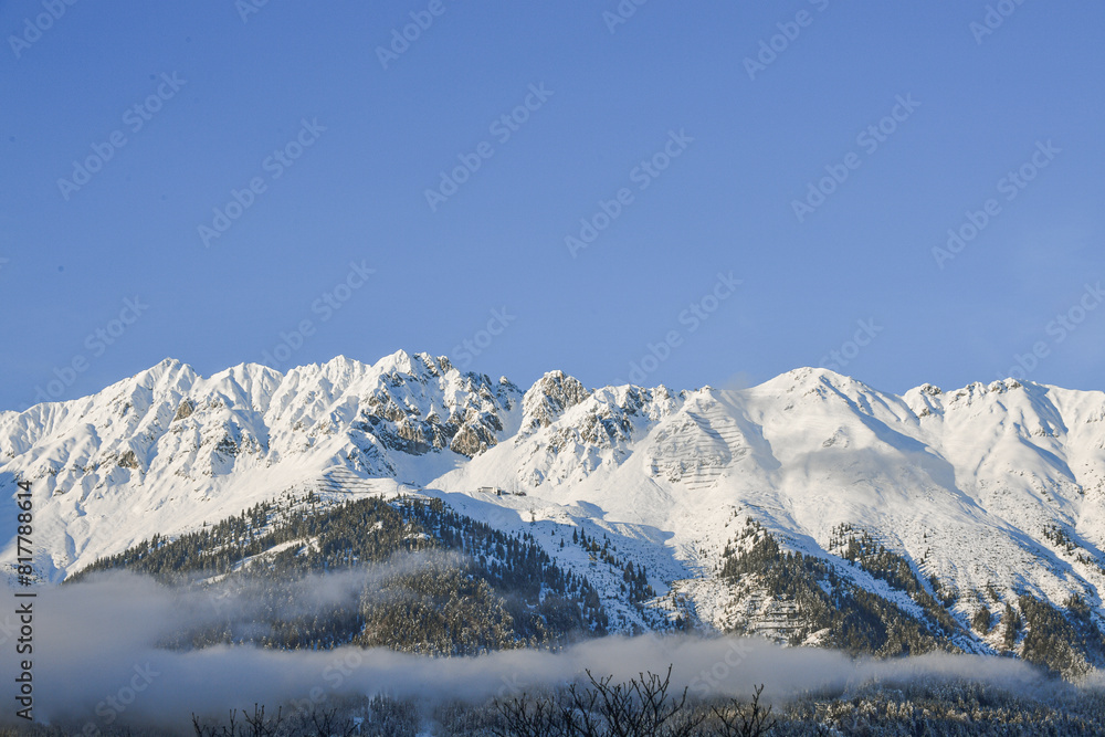 Fototapeta premium The mountains of the Nordkette surround Innsbruck in Tyrol with the summit Hafelekar