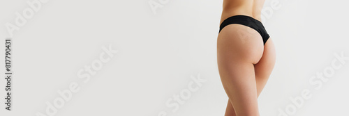 Cropped image of female buttocks and legs with smooth skin. Anti-cellulite care. Model posing in underwear isolated on grey background. Concept of skin care, sport, wellness, health. Banner