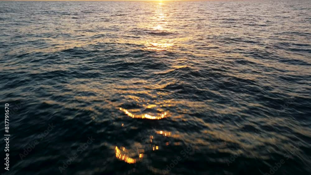 Aerial view of sunset horizon over the sea. Cinematic drone aerial view beautiful evening sunset in sky over sea.