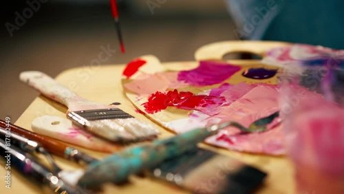 Wallpaper Mural in an art studio an artist sitting dips a brush in red paint on a palette Torontodigital.ca