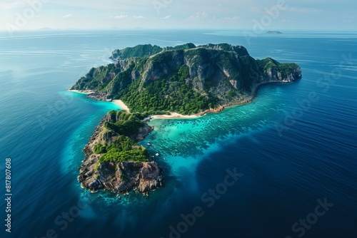 A small island in the middle of the ocean with another island photo