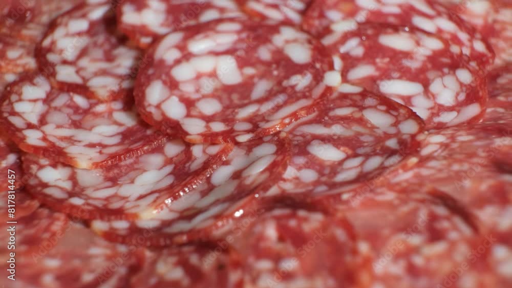 Thin slices of smoked sausage spinning close-up. Thin slices of smoked sausage spinning close-up.