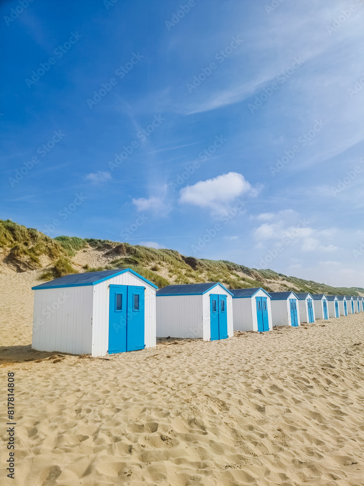 A vibrant row of colorful beach huts lines the sandy beach of Texel, Netherlands, creating a picturesque scene against the backdrop of the ocean. A vibrant row of colorful beach huts lines the sandy beach of Texel, Netherlands, creating a picturesque scene against the backdrop of the ocean.