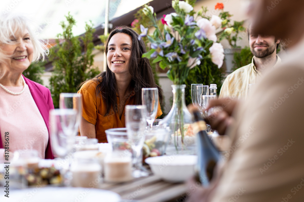 Storytelling image of a multiethnic group of people dining on a rooftop. Family and friends make a reunion at home ad dining outdoor. Storytelling image of a multiethnic group of people dining on a rooftop. Family and friends make a reunion at home ad dining outdoor.