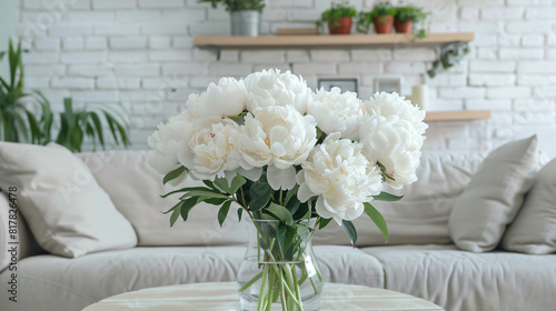 Vase of white peonies on coffee table couch 