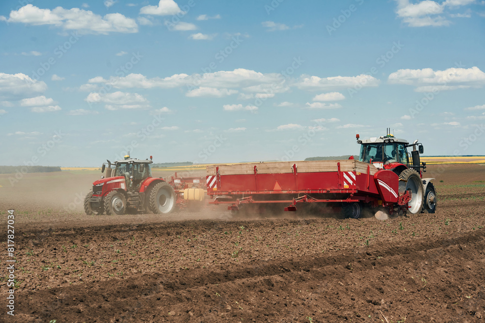 Obraz premium Riding, side view. Agricultural machinery, tractor on the field. Conception of harvest