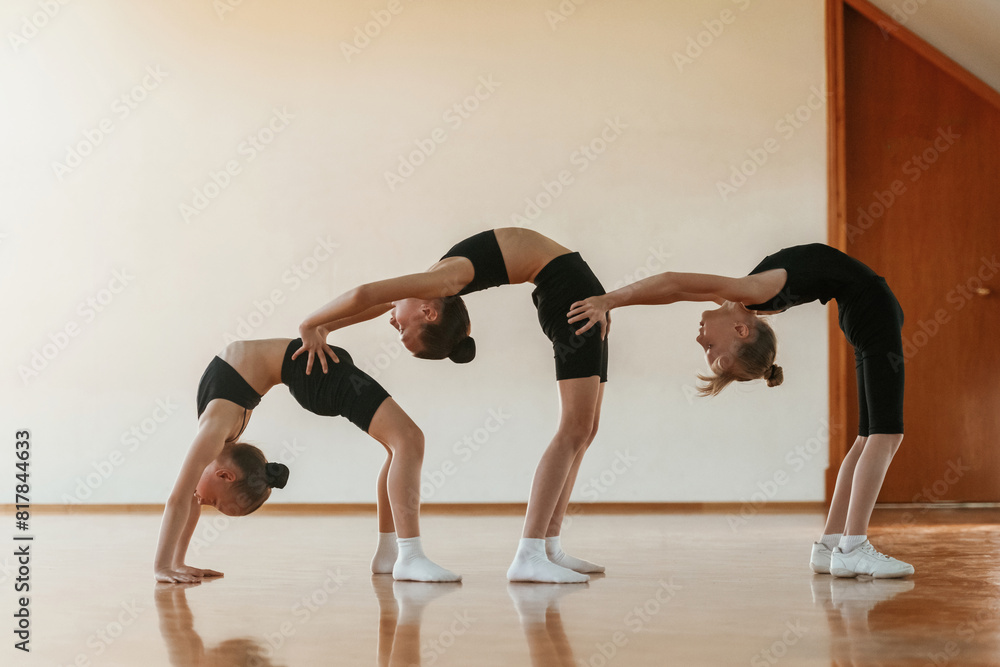Kids are doing athletic exercises indoors together Kids are doing athletic exercises indoors together