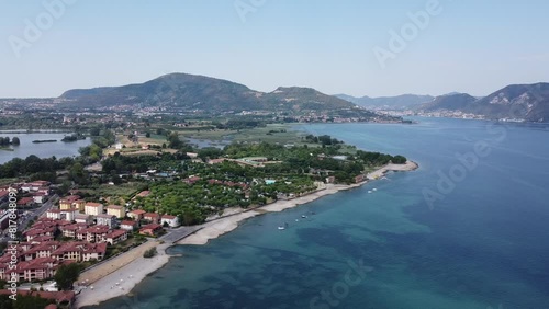 Drone footage of the buildings on the shore of Lake Iseo (Sebino) on a sunny day in Lombardy, Italy photo