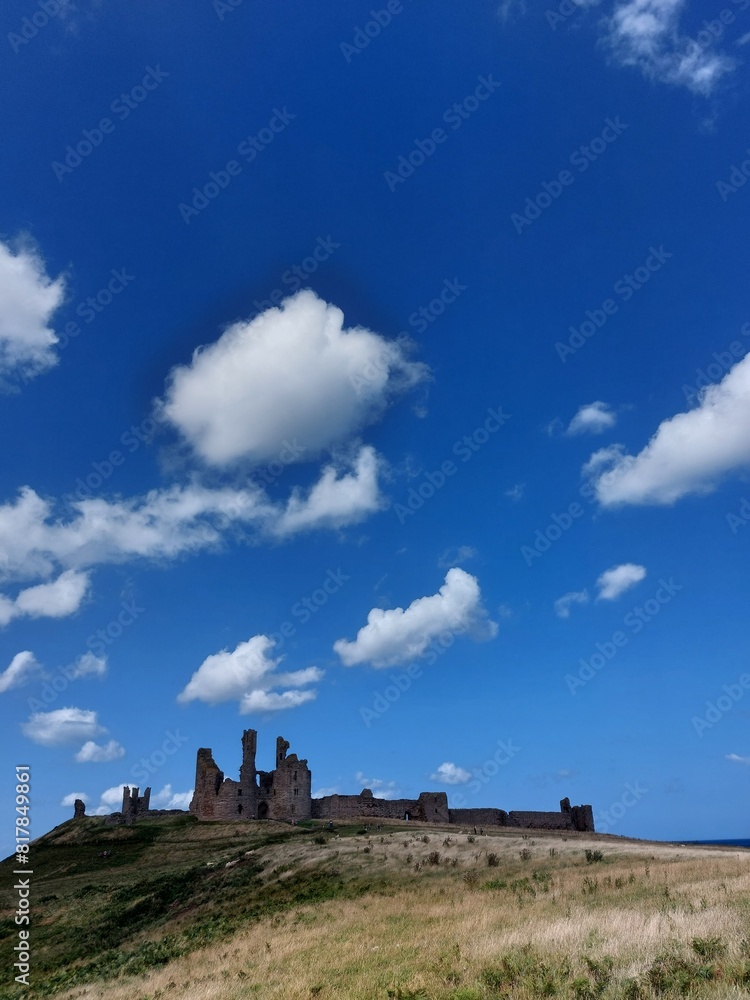 Ancient castle on a hill under a blue sky on a sunny day Ancient castle on a hill under a blue sky on a sunny day