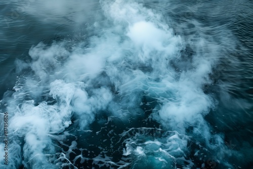 A surreal image of thick white smoke or mist floating over deep, dark water creating an ethereal and atmospheric scene.
