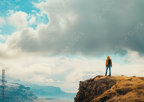Solo Traveler Hiking on Mountain Ridge with Dramatic Sky