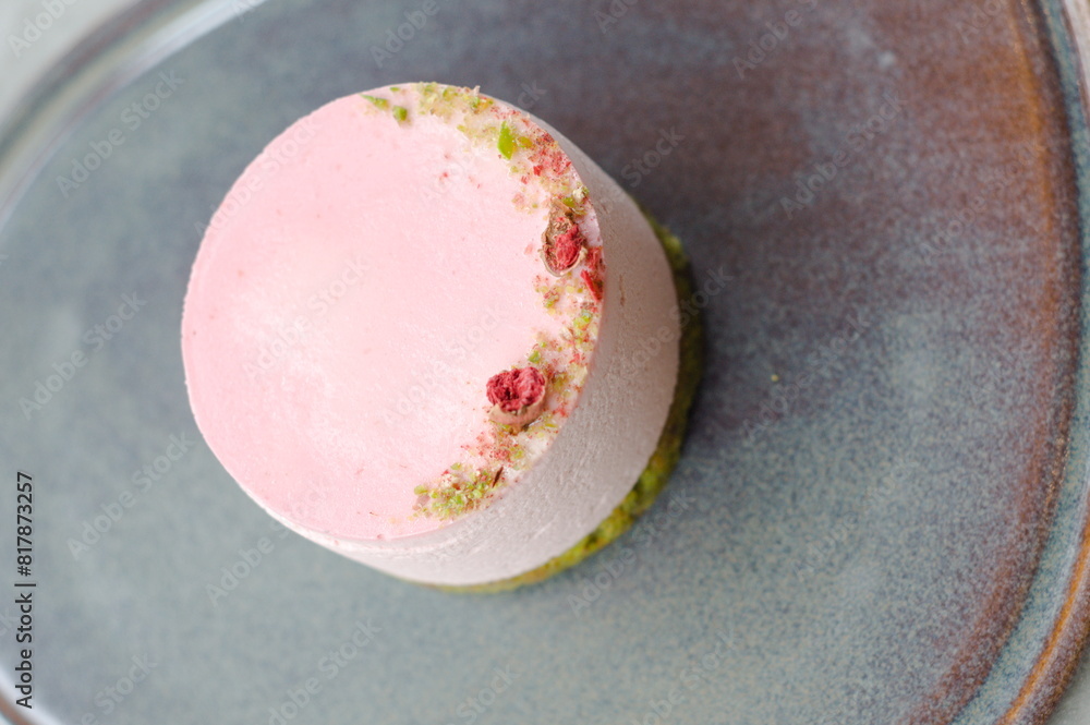 close up pink round cake on grey plate. top view close up pink round cake on grey plate. top view