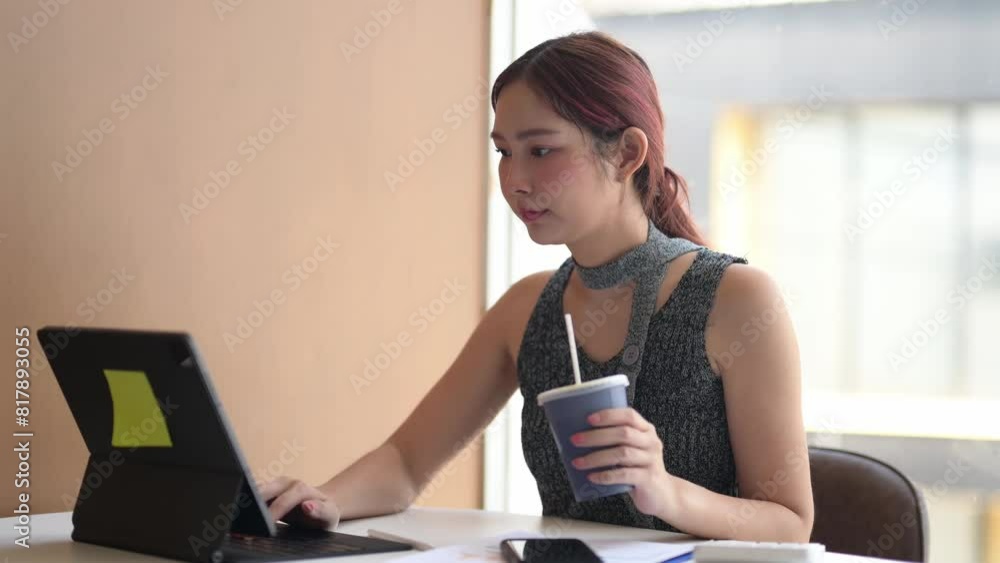 A young woman is working in a cafe enjoying coffee. A young woman is working in a cafe enjoying coffee.