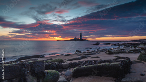 Sunrise over St Mary's Lighthouse and island at Whitley Bay on the north east coast of England, UK.