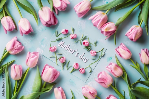 pink tulips and greeting card on blue background  flat lay