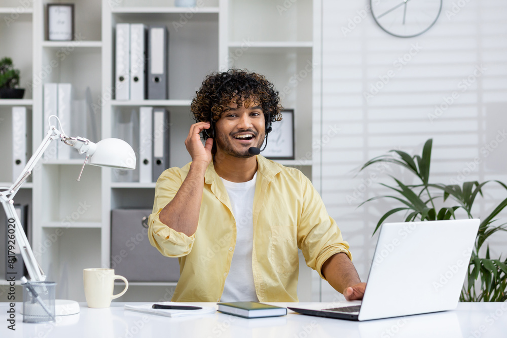 Smiling customer service representative with headset working at laptop in modern office setting, providing excellent support. Smiling customer service representative with headset working at laptop in modern office setting, providing excellent support.
