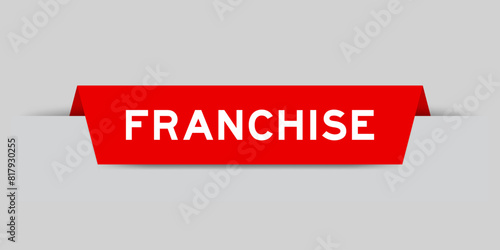 Red color inserted label with word franchise on gray background