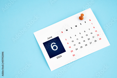 June 2024 calendar page with push pin on blue background.
