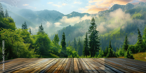 View from the empty wooden terrace over the mountains and forest in summer morning fog. Nature relax wallpaper.