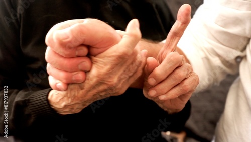 Schilderij op canvas Hugs of an old hundred-year-old woman and the young hands of an adult son, symbolizing support, understanding and connection between generations, Close-up