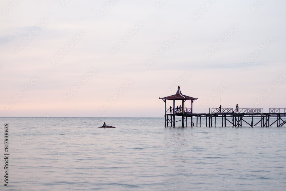 Riding a canoe on the sea during a sunset Riding a canoe on the sea during a sunset