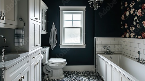 a classic bathroom adorned with black walls  white cabinets  and vintage floral wallpaper above the toilet bowl  complemented by modern farmhouse-style decor and a large window facing the bathtub.