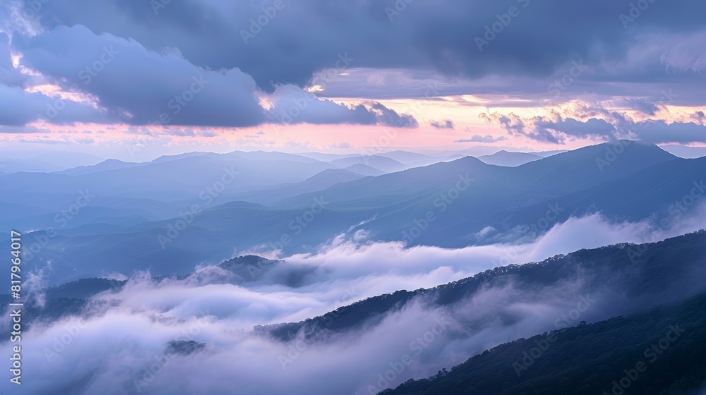 Mountains emerging from clouds at dawn
