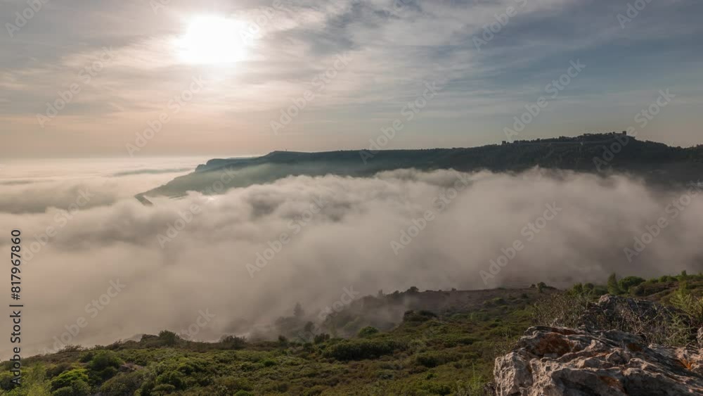 Panorama showing aerial View of Sesimbra Town and Port covered by fog timelapse, Portugal. Top landscape above the clouds and setting sun. Resort in Setubal district Panorama showing aerial View of Sesimbra Town and Port covered by fog timelapse, Portugal. Top landscape above the clouds and setting sun. Resort in Setubal district