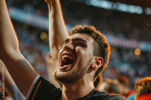 A young guy joyfully cheering  in the stadium during an event match