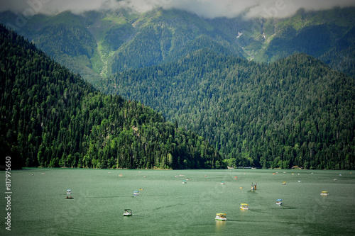 Catamarans on Lake Ritsa in Abkhazia. Walks on the water. Ecologically clean place in the mountains photo