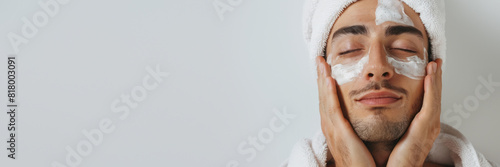Man with facial mask enjoying spa treatment photo