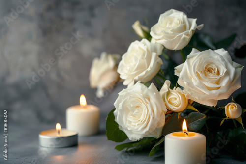 Somber and respectful condolence background featuring elegant white roses and glowing candles on a textured grey surface