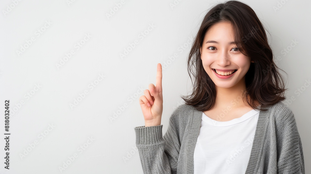 Japanese woman happily gestures, pointing up Japanese woman happily gestures, pointing up