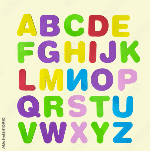 Back to class. Alphabet letters arranged on a white background. Coloured letters. Vista superior.