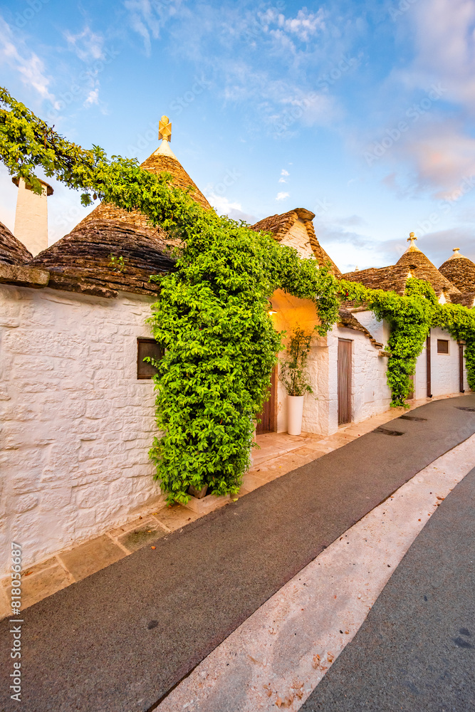 Trulli of Alberobello, Puglia, Italy. town of Alberobello with trulli houses among green plants and flowers