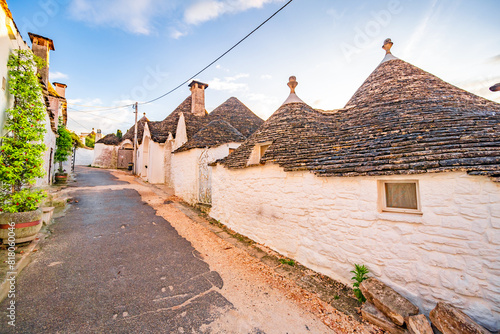 Trulli of Alberobello, Puglia, Italy. town of Alberobello with trulli houses among green plants and flowers