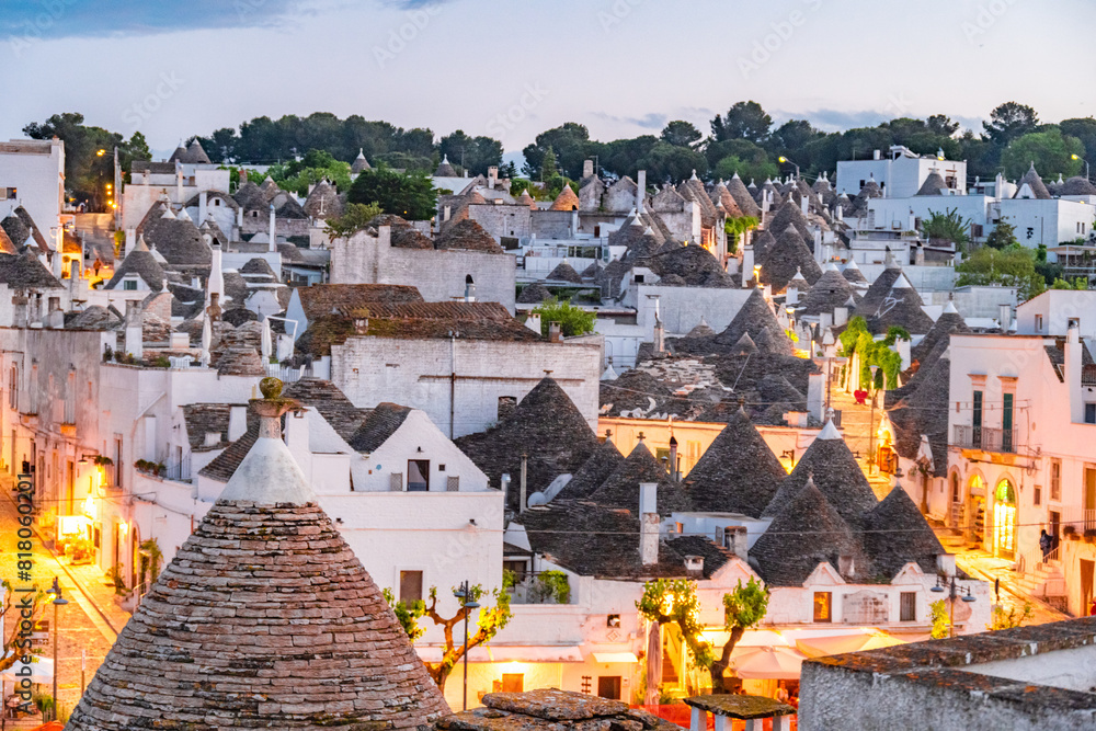 Fototapeta premium Trulli of Alberobello, Puglia, Italy. town of Alberobello with trulli houses among green plants and flowers