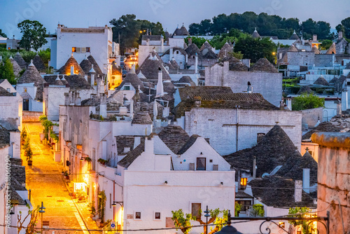 Trulli of Alberobello, Puglia, Italy. town of Alberobello with trulli houses among green plants and flowers