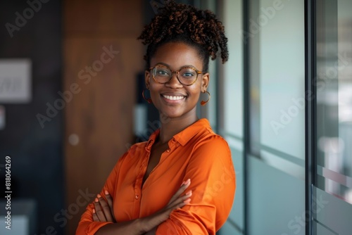 Eyeglasses Orange. Portrait of Smiling Businesswoman with Arms Crossed in Modern Office. Successful Career Concept