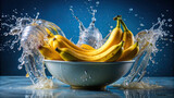 A bunch of bananas being dipped into a basin of water, eliciting playful splashes 