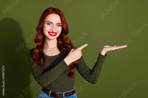 Photo of shiny attractive lady dressed shirt showing arm pointing finger empty space isolated green color background © deagreez
