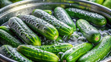 Freshly picked cucumbers being cleaned in a basin of water, with bubbles forming around them, highlighting the importance of hygiene in food preparation.