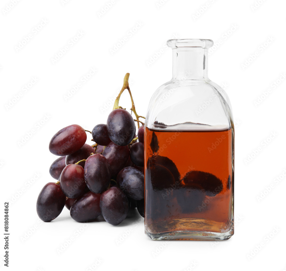 Bottle with wine vinegar and grapes isolated on white Bottle with wine vinegar and grapes isolated on white