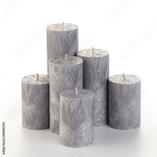 Natural grey palm wax pillar candles of varying heights; featuring unique ice pattern texture grouped on white background. Handmade accessories for refreshing interior decor