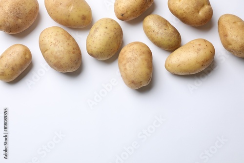 Fresh raw potatoes on white background  flat lay. Space for text