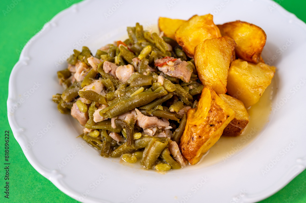 Green beans with tuna fish piece and baked potato on white plate. Green beans with tuna fish piece and baked potato on white plate.