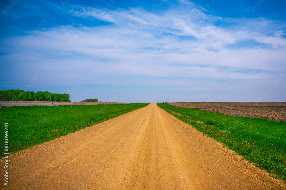 Dirt road, horizon, and the big sky: Tranquil midwestern farmland summer landscape in Hartford, Minnehaha County, South Dakota Dirt road, horizon, and the big sky: Tranquil midwestern farmland summer landscape in Hartford, Minnehaha County, South Dakota