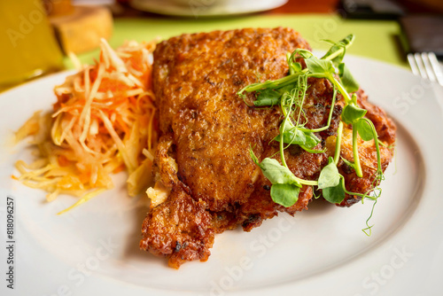 Fried pork meat in potato dough, carrot and cabbage salad, sprouted pea leaf.