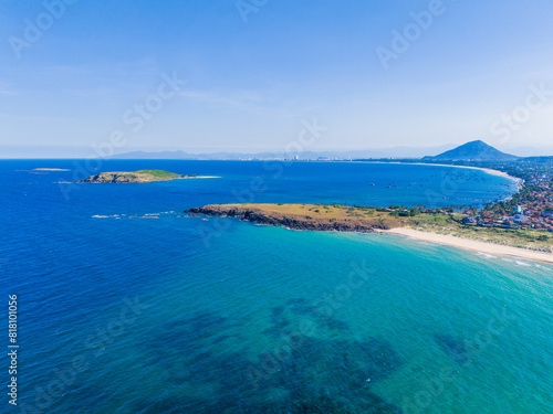 Aerial view of Bai Xep beach in Phu Yen province, Vietnam. Tropical coast from cliff above. Vietnam travel destination, golden sand beach waving sea rock boulders.