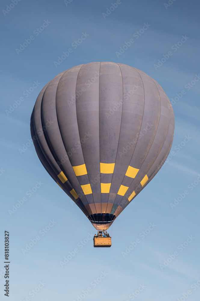 Naklejka premium A big, hot air balloon, floating in a blue summers sky
